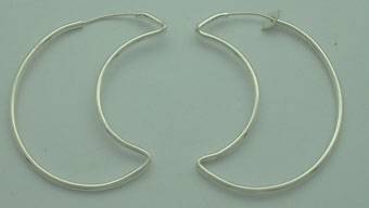 Big pendant earring of thin smooth wire in moon.