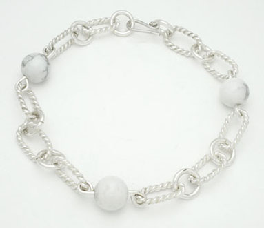 Bracelet ovals in spiral with balls of white plastic