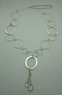 Necklace of circles of wire and cord and smooth ovals