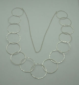 Necklace of 15 rings hammered with a part of chain.
