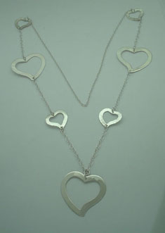 Necklace of 3 smooth big hearts and 4 hammered small hearts linked with chain