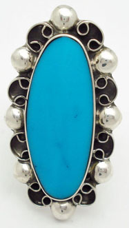 Ring with  oval  of resin turquoise with curls and spheres