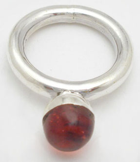 Ring with sphere of red plastic