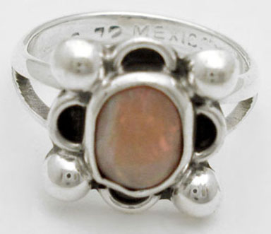 Ring with glass sunflower and spheres with waves
