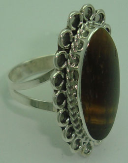 Oval ring with cord in flower with tiger eye
