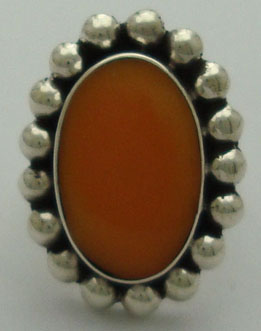 Oval ring with spheres and orange resin
