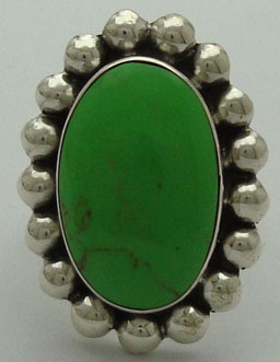 Oval ring with spheres and synthetic stone green