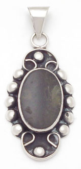 Pendant of shell with curl oxidizeds and spheres
