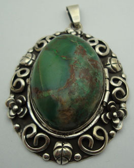 Oval earring of Chrysocolla with curls and leafs oxidizeds